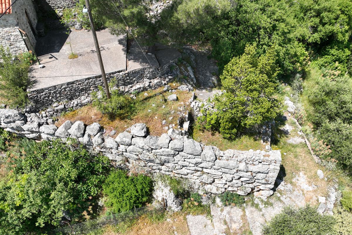  the ancient wall a the NE side, below the church of Agioi Taxiarches